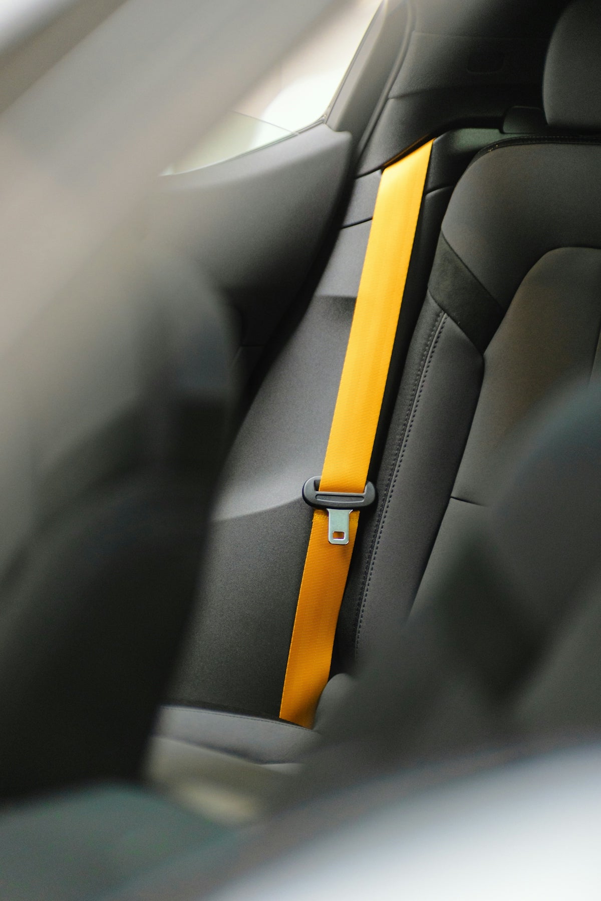 a car seat with a yellow strip on it