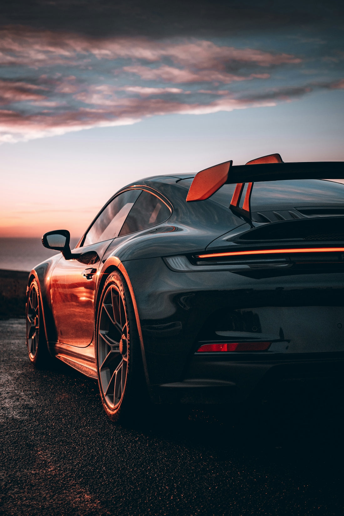 A black sports car parked on the side of a road