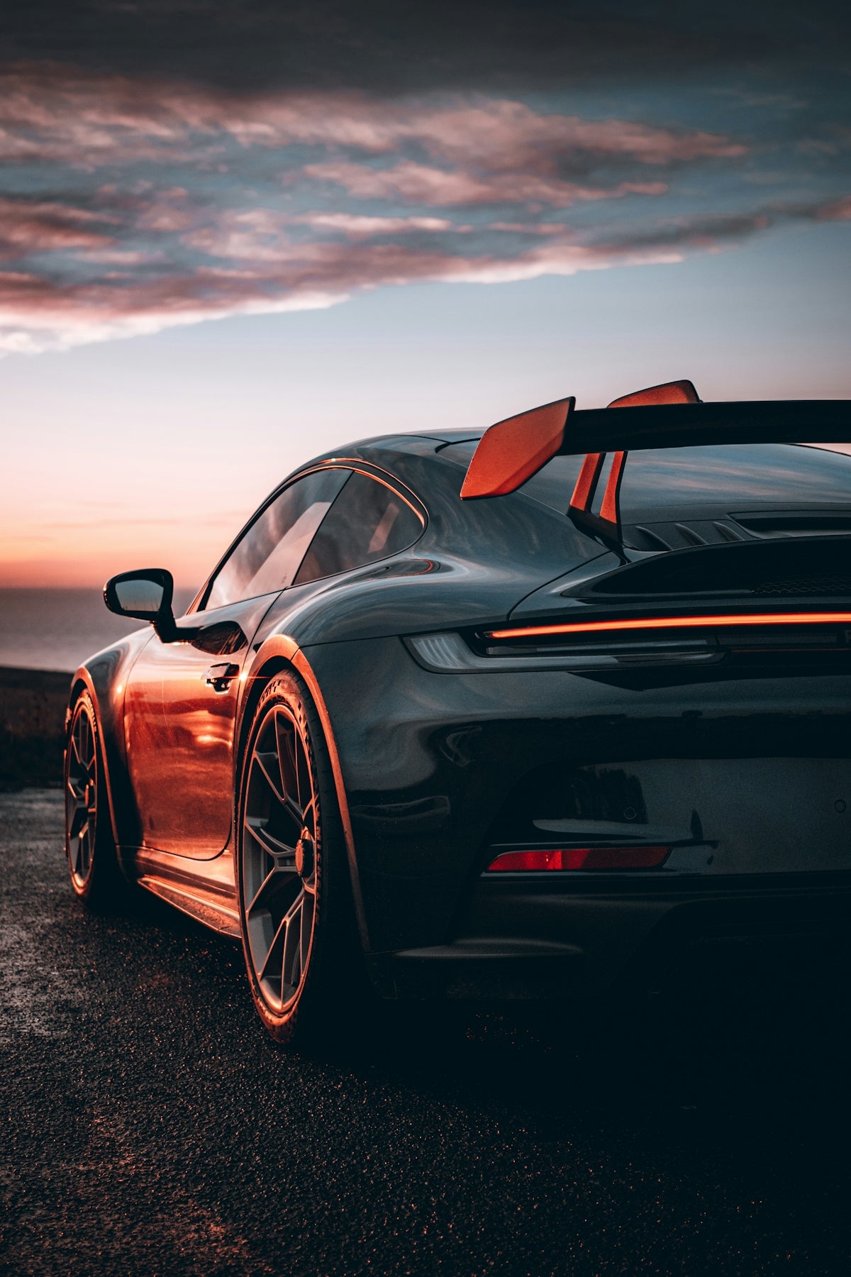 A black sports car parked on the side of a road